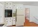 Spacious kitchen features white cabinets, wood floors, and modern appliances at 3240 Corktree Trl, Stonecrest, GA 30038