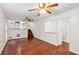 Open-concept living area with hardwood floors, view of the kitchen, and staircase at 3240 Corktree Trl, Stonecrest, GA 30038