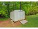 White outdoor storage shed on a well-maintained lawn at 3240 Corktree Trl, Stonecrest, GA 30038