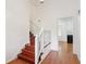 View of the home's staircase, that leads to the upper level near the kitchen at 3240 Corktree Trl, Stonecrest, GA 30038