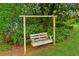 Inviting backyard wooden swing provides a relaxing outdoor escape amidst lush greenery at 3240 Corktree Trl, Stonecrest, GA 30038