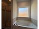 Bathroom featuring a garden tub and glass enclosed shower at 5301 Tuscany Dr, Douglasville, GA 30135