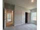 This bedroom features neutral walls, carpet, closet and a large window for natural light at 5301 Tuscany Dr, Douglasville, GA 30135