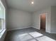 This bedroom features neutral walls, carpet and a closet, and a large window for natural light at 5301 Tuscany Dr, Douglasville, GA 30135