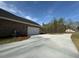 Long, paved driveway leading to a brick home with an attached garage at 5301 Tuscany Dr, Douglasville, GA 30135