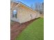 Brick exterior and green lawn showcasing the side view of the house at 5301 Tuscany Dr, Douglasville, GA 30135