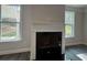 Cozy fireplace with large windows for ample natural light in the living area at 5301 Tuscany Dr, Douglasville, GA 30135