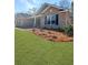 Well-maintained lawn with landscaping near brick home with covered entryway and black shutters at 5301 Tuscany Dr, Douglasville, GA 30135