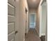 Hallway with white trim and carpet and neutral walls and interior doors at 5301 Tuscany Dr, Douglasville, GA 30135