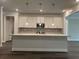 Bright kitchen with white cabinets, marble countertops, and stainless steel appliances at 5301 Tuscany Dr, Douglasville, GA 30135