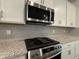 Kitchen with stainless steel microwave, gas stove, and granite countertops at 5301 Tuscany Dr, Douglasville, GA 30135