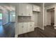 Eat-in kitchen, dark hardwood floors, and modern white cabinets with granite countertops at 5301 Tuscany Dr, Douglasville, GA 30135