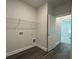 Functional laundry room features ample shelving, washer and dryer hookups, and vinyl flooring at 5301 Tuscany Dr, Douglasville, GA 30135