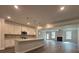 Open-concept living room and kitchen with island, fireplace, and light hardwood floors at 5301 Tuscany Dr, Douglasville, GA 30135