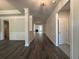 Open-concept living space with hardwood floors and elegant trim detail throughout the hallway at 5301 Tuscany Dr, Douglasville, GA 30135