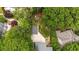 Aerial view of a property showcasing a well-maintained lawn, detached garage, patio, and mature trees at 1590 Johnson Ne Rd, Atlanta, GA 30306