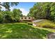 Large backyard showcasing a detached garage, a fire pit with seating, and mature trees at 1590 Johnson Ne Rd, Atlanta, GA 30306