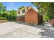 Backyard with brick and siding home with a screened in porch and a large concrete patio area at 1590 Johnson Ne Rd, Atlanta, GA 30306