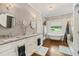 Bright bathroom featuring double sinks, modern fixtures, and a soaking tub with backyard views at 1590 Johnson Ne Rd, Atlanta, GA 30306