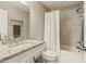 Bathroom featuring granite countertops, modern fixtures, and a shower-tub combo at 1590 Johnson Ne Rd, Atlanta, GA 30306
