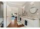 Bathroom featuring double sinks, modern fixtures, and hardwood floors with a bedroom view at 1590 Johnson Ne Rd, Atlanta, GA 30306