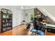 Cozy room featuring hardwood floors, a modern desk setup, and unique stone accent wall at 1590 Johnson Ne Rd, Atlanta, GA 30306