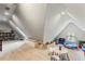 Attic bonus room featuring carpet flooring, built-in shelves, and ample space for play and storage at 1590 Johnson Ne Rd, Atlanta, GA 30306