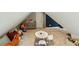 Attic bonus room with sloped ceilings, neutral carpet, seating, shelving and a bright blue accent wall at 1590 Johnson Ne Rd, Atlanta, GA 30306