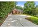 Long driveway leading to a brick home with lush greenery, offering privacy and ample parking space at 1590 Johnson Ne Rd, Atlanta, GA 30306