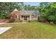 Charming brick home with a well-manicured front yard, cozy porch, and beautiful landscaping at 1590 Johnson Ne Rd, Atlanta, GA 30306