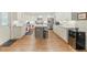 Modern kitchen with white cabinets, a center island, stainless steel appliances, and hardwood flooring at 1590 Johnson Ne Rd, Atlanta, GA 30306