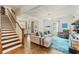 Open-concept living area with hardwood floors, a staircase, and modern decor, perfect for entertaining guests at 1590 Johnson Ne Rd, Atlanta, GA 30306
