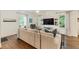 Bright living room featuring hardwood floors, a large TV, and windows that bring in lots of natural light at 1590 Johnson Ne Rd, Atlanta, GA 30306