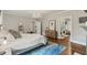 This main bedroom features hardwood floors, a chandelier, and an ensuite bathroom with a view at 1590 Johnson Ne Rd, Atlanta, GA 30306