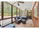 Screened-in back patio features a hot tub, overhead fans and wooded views at 1590 Johnson Ne Rd, Atlanta, GA 30306