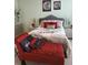 Cozy bedroom with chaise lounge, decorative pillows, and framed art above bed at 2118 Burns View Ln, Lawrenceville, GA 30044