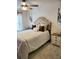 A stylish bedroom featuring a neutral color scheme, a plush headboard and elegant bedside table at 2118 Burns View Ln, Lawrenceville, GA 30044