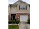 A charming townhouse with a brick facade, neutral siding, and a one-car garage at 2118 Burns View Ln, Lawrenceville, GA 30044