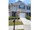 Attractive townhouse features a brick facade, one-car garage, and well-maintained landscaping at 2118 Burns View Ln, Lawrenceville, GA 30044
