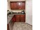 Traditional-style kitchen featuring wood cabinets, gray countertops, and a tiled floor at 2118 Burns View Ln, Lawrenceville, GA 30044