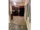 Kitchen featuring dark wood cabinets, black appliances, and a window at 2118 Burns View Ln, Lawrenceville, GA 30044
