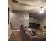 Cozy living room featuring hardwood floors, comfortable seating, and a view of the dining area at 2118 Burns View Ln, Lawrenceville, GA 30044