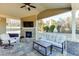 Inviting covered back porch with outdoor seating, fireplace, and view of the backyard at 2225 Independence Ln, Buford, GA 30519
