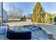 A backyard featuring a stone patio with outdoor seating, a well-maintained lawn, and lush trees at 2225 Independence Ln, Buford, GA 30519