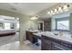 Bright bathroom with double vanity, tile floor, and view of the main bedroom at 2225 Independence Ln, Buford, GA 30519
