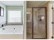 Bathroom featuring stand-up shower, window over a tub, and tiled walls at 2225 Independence Ln, Buford, GA 30519