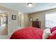 Cozy bedroom featuring comfortable bed with red quilt and view to bathroom and closet at 2225 Independence Ln, Buford, GA 30519