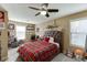 Bedroom with ceiling fan, carpeted floors, natural lighting and plaid bedding at 2225 Independence Ln, Buford, GA 30519