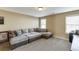 Spacious bonus room with a sectional sofa, neutral walls, and carpet flooring at 2225 Independence Ln, Buford, GA 30519
