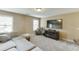 Bonus room featuring a comfy sofa, media center, and neutral colored walls at 2225 Independence Ln, Buford, GA 30519